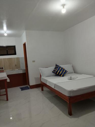 a living room with a bed and a couch at Mangas Residents in El Nido