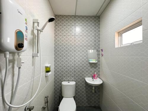 a bathroom with a shower and a toilet and a sink at QUDWAHSTAY in Kota