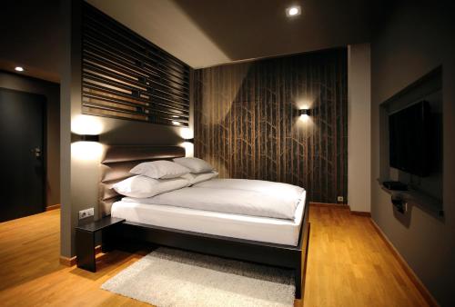 a bedroom with a bed and a flat screen tv at Gateway Budapest Centrum in Budapest