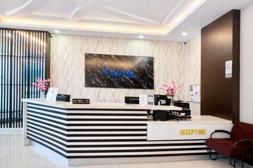 a lobby with a reception desk in a building at Avatel Jelutong PWCC in George Town