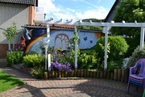 a mural of a rainbow on the side of a house at Ferienwohnung Anneli Edert in Bad Harzburg