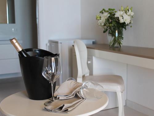 a table with a bottle of wine and a glass at Villa Principe Di Belmonte in Ispica