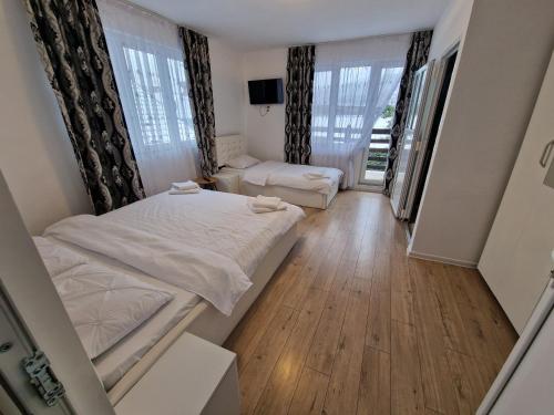 a small bedroom with a bed and a couch at PENSIUNEA NASUI in Vişeu de Sus
