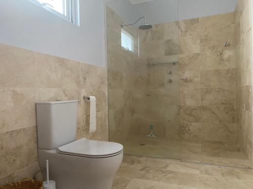a bathroom with a toilet and a shower at Southerly Studio in Augusta