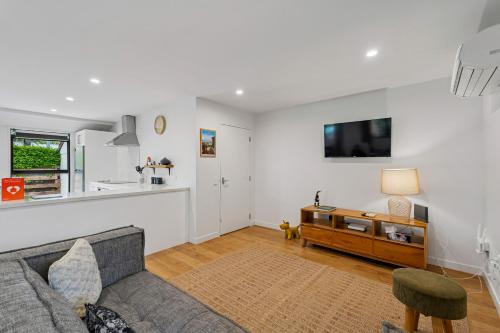 a living room with a couch and a table at Rees on Reid - Arrowtown Holiday Home in Arrowtown
