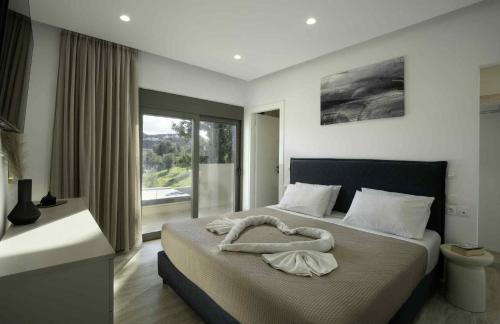 a bedroom with a bed with a large window at Villa Kennedy in Faliraki