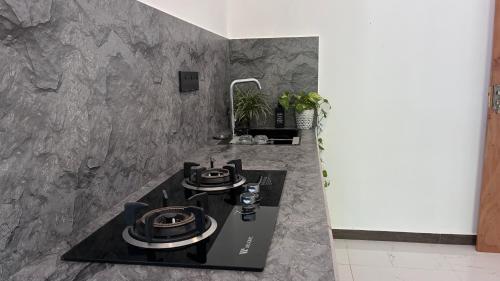 a kitchen with a black counter and a sink at Handagedara Madiha Villa in Matara