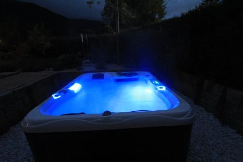 a blue hot tub in a yard at night at Villa Montelago in Rottach-Egern