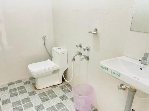 a bathroom with a toilet and a sink at Grace villa in Mandrem