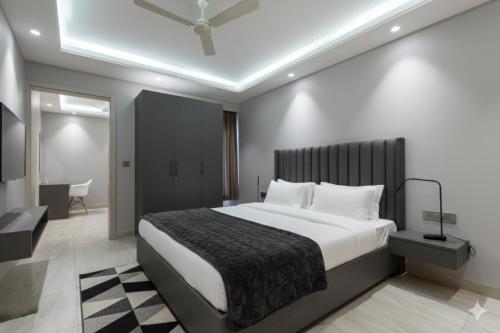a bedroom with a large bed in a room at Hotel Xotic Avenue in Gurgaon