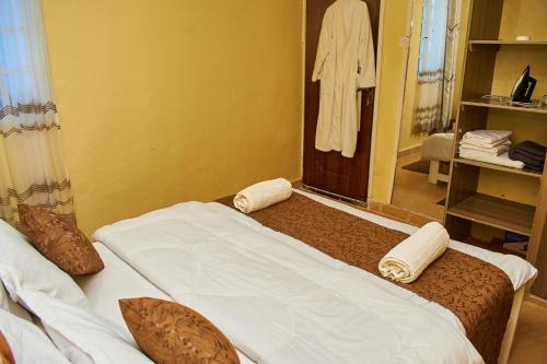 a bedroom with a bed with towels on it at Kajole Homestay in Kakamega