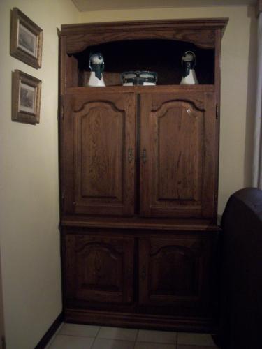 a wooden hutch with two birds on top of it at FILD - Holiday Apartment in Saint-Vith