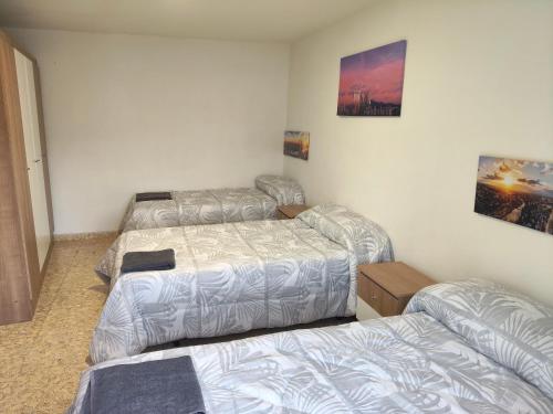 a room with three beds in a room at La posada del Mozarabe in Alquife