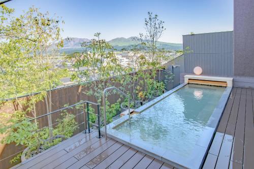 a balcony with a swimming pool on a building at Aso Hotel in Aso
