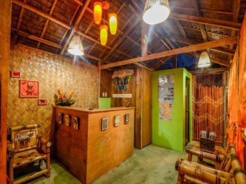 a room with a bar in a restaurant with aperature at OYO 622 Butterfly Totem Guesthouse in Puerto Princesa City