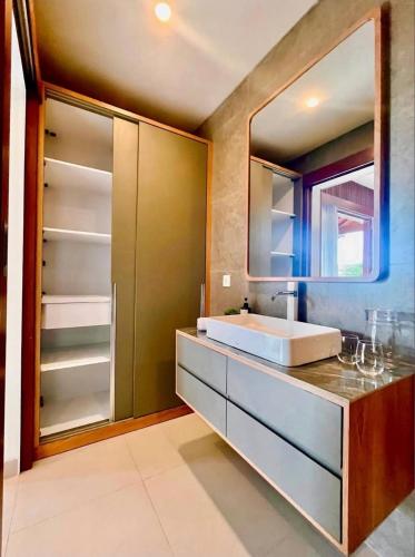a bathroom with a sink and a mirror at Parama Swaha Villa Near Canggu in Munggu