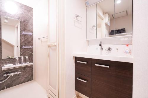 a bathroom with a sink and a shower at 新築Sunbright Asakusa 101 in Tokyo