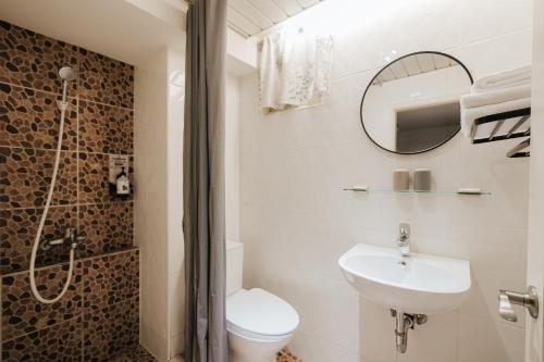 a bathroom with a toilet and a sink and a shower at Meworld Hotel - Zhongshan in Taipei