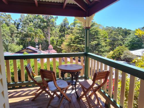 a porch with two chairs and a table on a deck at Bridgefield Guest House in Margaret River Town