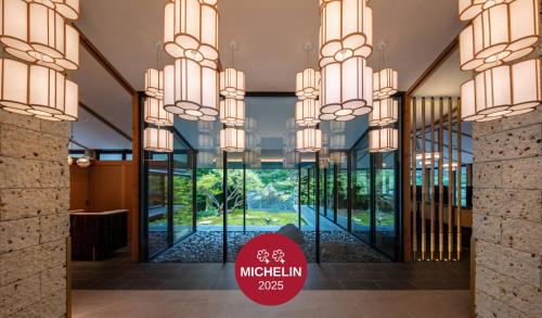 a lobby with glass doors and a sign that reads mucinnin at Fufu Nikko in Nikko