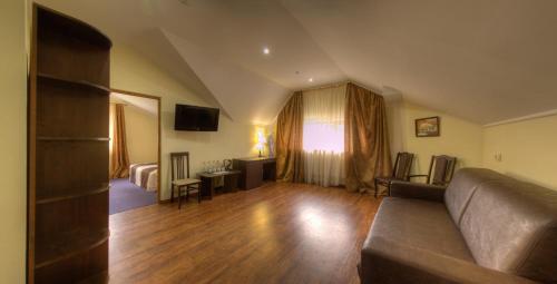 a living room with a couch and a table at Home Hotel in Bukovel