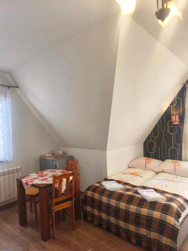 a bedroom with a bed and a table and a table and chairs at U Celiny - Widok na Tatry - Region Białki Tatrzańskiej in Rzepiska