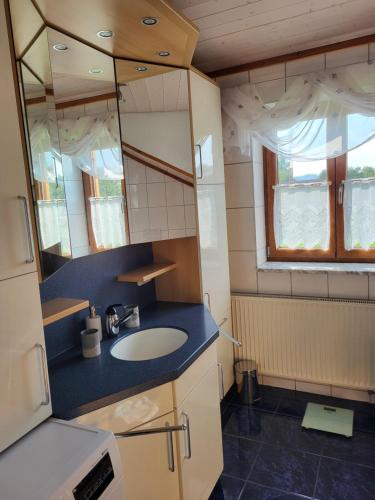 a bathroom with a sink and a mirror at Ferienwohnung Czanderl in Dießen am Ammersee