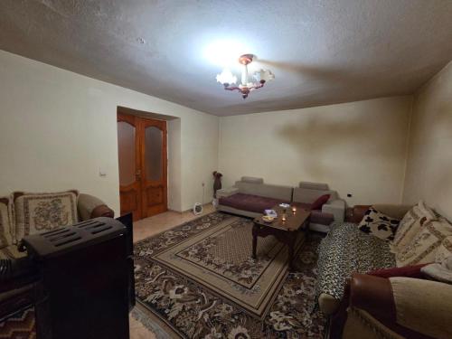 a living room with a couch and a table at Business Hostel in Korçë