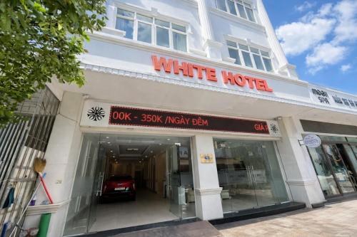 a white hotel with a car inside of it at White Hotel Nghệ An in Vinh