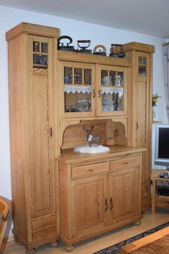 a wooden cabinet with a sink in a room at Allgäuschönheit inkl BadHindelangPlus Karte in Bad Hindelang