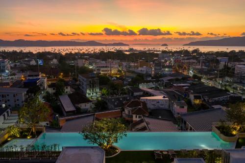 a view of a city at sunset at HOMA Chalong Bay in Ban Klang