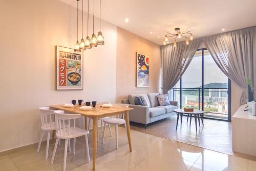 a dining room and living room with a table and chairs at Iconic Regency by Stellar ALV in Bayan Lepas