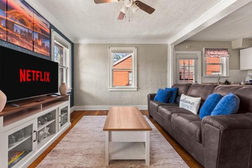 a living room with a couch and a tv at Charming 1 Bedroom Duplex in Memphis 2 Miles from Midtown and Crosstown Free WiFi Pet Friendly in Memphis