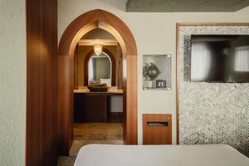 a hallway with a bathroom with a sink and a mirror at Nesthotel alt Kawasaki Station in Kawasaki
