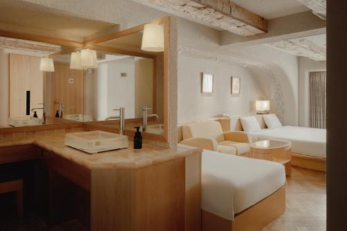 a bathroom with a sink and a bed in a room at Nesthotel alt Kawasaki Station in Kawasaki