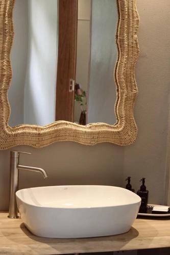 a bathroom sink with a large mirror on a counter at Mkhuze Trails Lodge in Hluhluwe