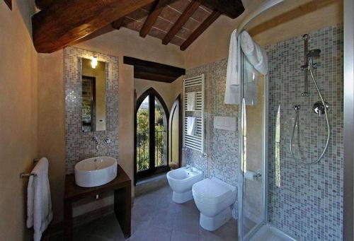 a bathroom with a sink and a toilet and a shower at Agriturismo Monastero Di San Biagio in Nocera Umbra