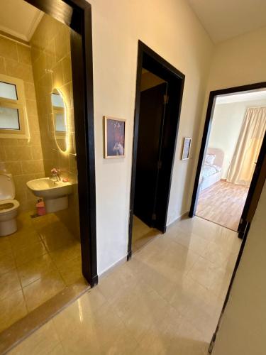 a bathroom with a toilet and a sink at Cozy crystal lounge in Sheikh Zayed