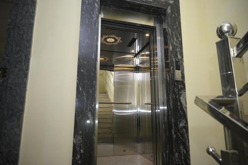 a bathroom with a shower with a silver door at hotel NemiResidency in Jagdalpur