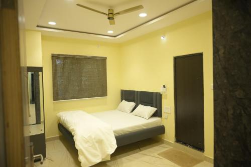 a bedroom with a bed and a window in it at hotel NemiResidency in Jagdalpur
