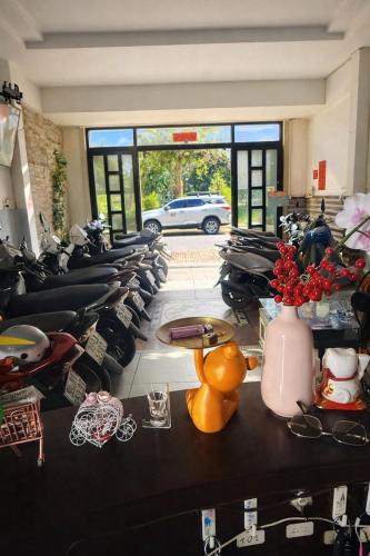 a row of motorcycles parked in a room at Hoàng Bách 3 Hotel in Ho Chi Minh City