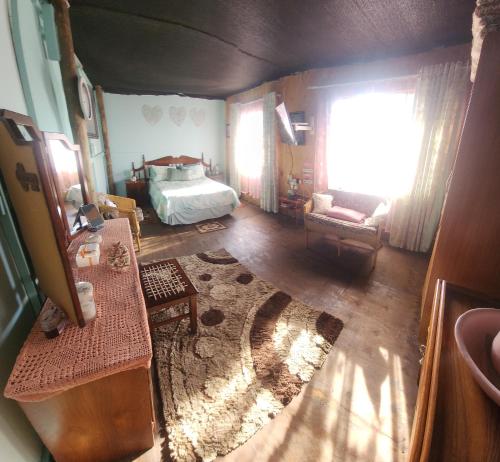a living room with a bed and a window at Buffelslaagte at the Vaal in Oranjeville