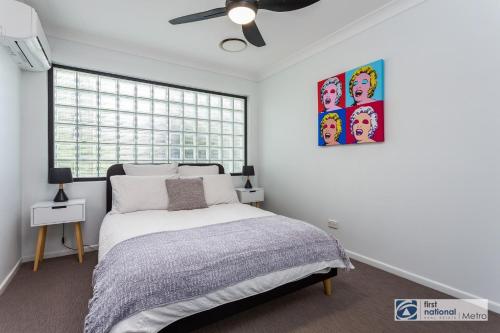a bedroom with a bed and a ceiling fan at Southbank Parkside Two-Bed Villa in Brisbane