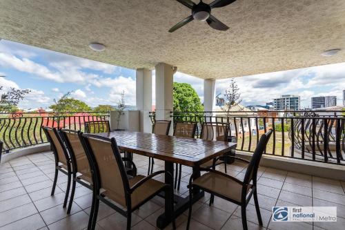 a table and chairs on a balcony with a view at Southbank Parkside Two-Bed Villa in Brisbane