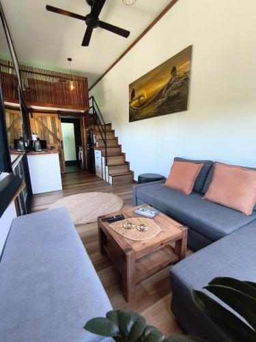 a living room with a couch and a table at Tiny House Experience in Sunset Strip