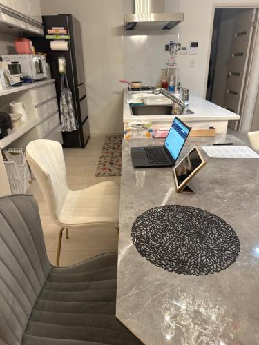 a kitchen counter with a laptop on top of it at any one in Chitose