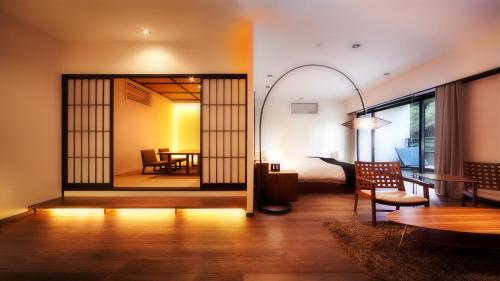 a living room with a door leading to a dining room at Premium Suites "Hanare Matsushimakaku" Produced by Shousuke no Yado Takinoyu in Aizuwakamatsu