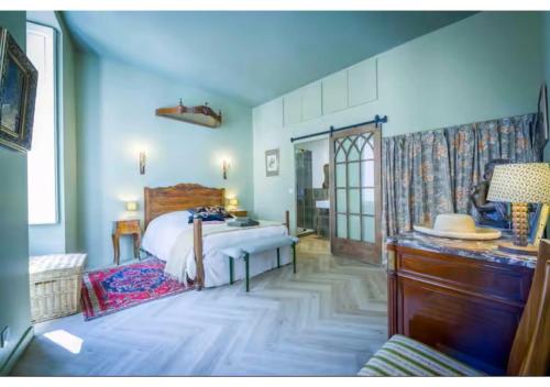 a bedroom with a bed and a table in it at Goncourt42 in Nîmes