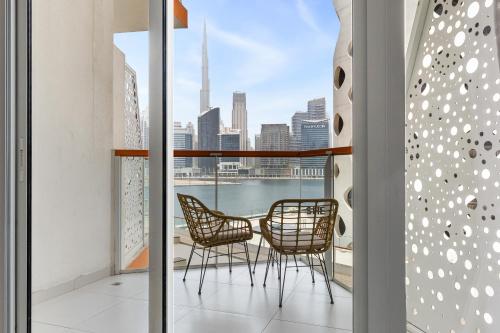 a balcony with chairs and a view of the city at Unlock Waters Edge in Dubai