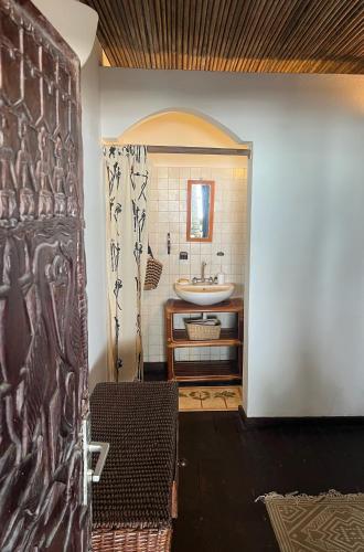 a bathroom with a sink and a shower at O'Sole Mio Assinie in Assinie